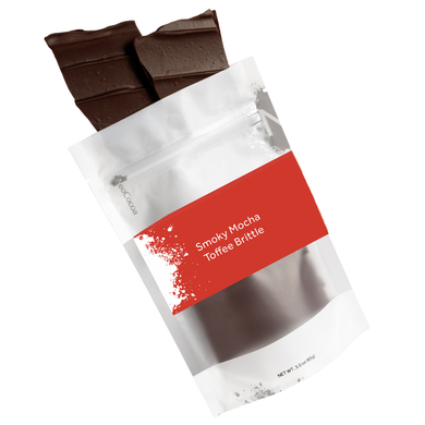 Smoky Mocha Toffee Brittle packaging with chocolate pieces on a white background