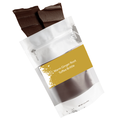 Warm ginger root brittle pouring out of 3oz sized bag with yellow label stating “Warm Ginger Root Toffee Brittle” and NeoCocoa logo on a white background.