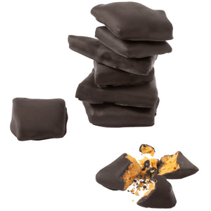 Stacked pile of chocolate covered honeycomb candy pieces and one piece of candy broken open to expose honeycomb candy inside.