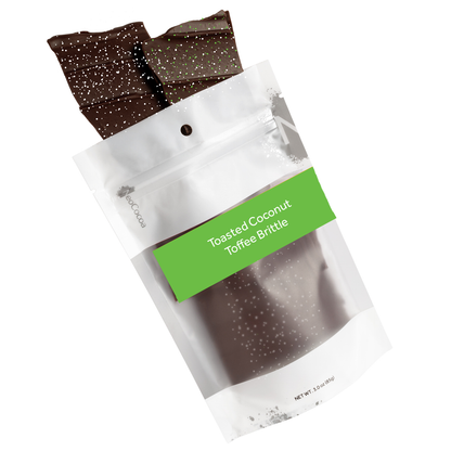 Toasted Coconut  brittle pouring out of 3oz sized bag with green label stating “Toasted Coconut Toffee Brittle” and NeoCocoa logo on a white background.