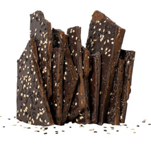 Load image into Gallery viewer, Close up of several pieces of sesame brittle candy vertically stacked.